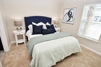 Bedroom with a medium-sized window, carpet flooring, and doorway leading out - Photo Gallery 8