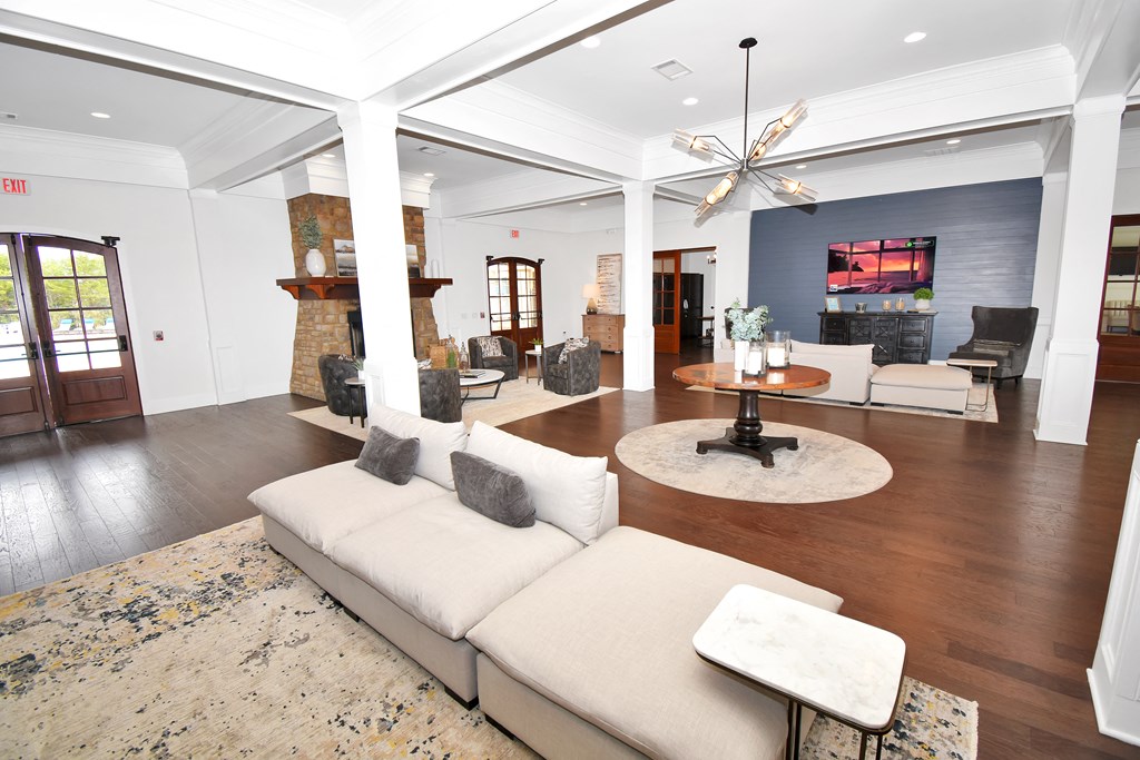 a clubhouse with couches, table and lighting