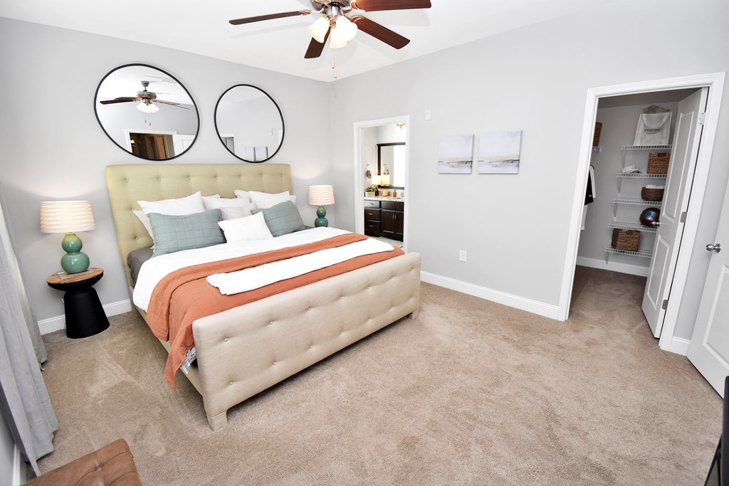 a bedroom with a bed and a ceiling fan