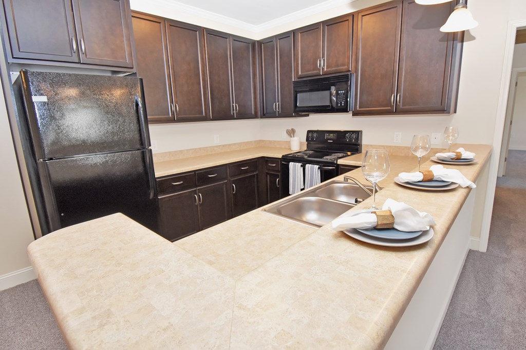 a kitchen with a large countertops and black appliances