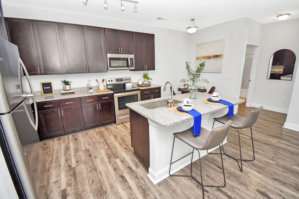 a kitchen and dining area with a table and chairs