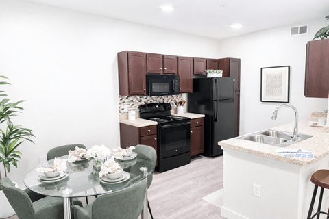A kitchen with a table set for six.