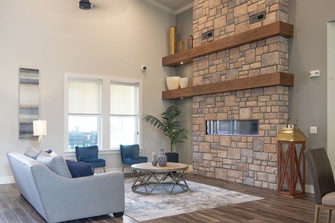 a clubhouse with a stone fireplace and a couch