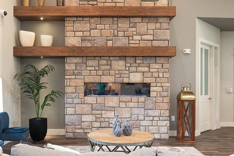 a stone fireplace in a living room with a coffee table