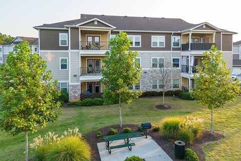 an apartment building with a courtyard with a picnic table