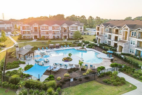 an aerial view of an apartment complex with a large swimming pool