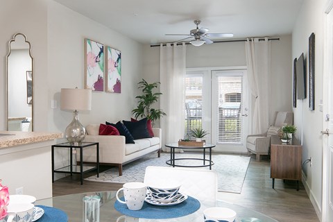 a living room with a couch and a ceiling fan