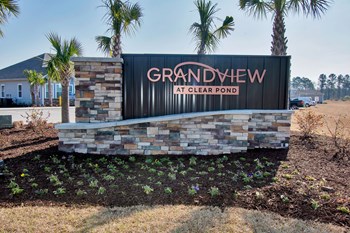 Grandview at Clear Pond outdoor stone entrance sign with flower bed and palm trees - Photo Gallery 17