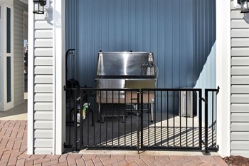 Covered and gated dog wash station with metal basin, wash hoses, and supplies - Photo Gallery 10