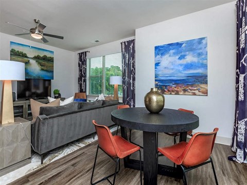 a living room with a table and chairs