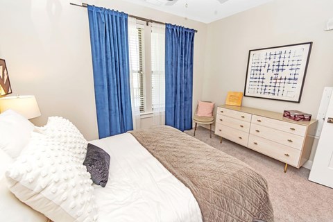 Bedroom with a dresser at Pointe at Research Park Apartments, Charlotte, North Carolina