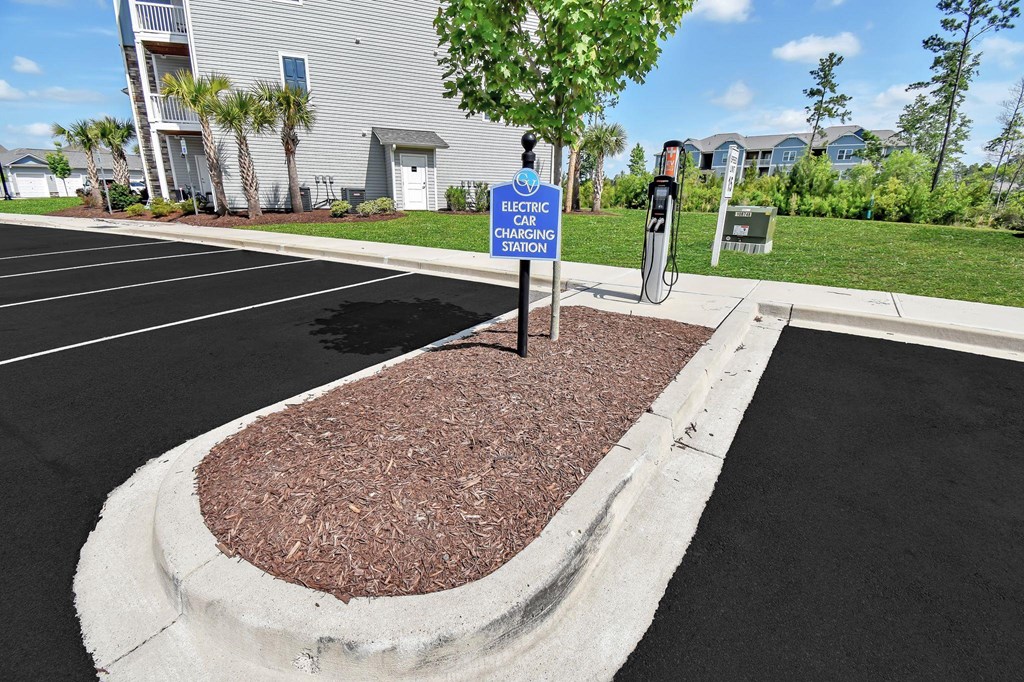 a parking lot with a blue and white sign in the middle of it