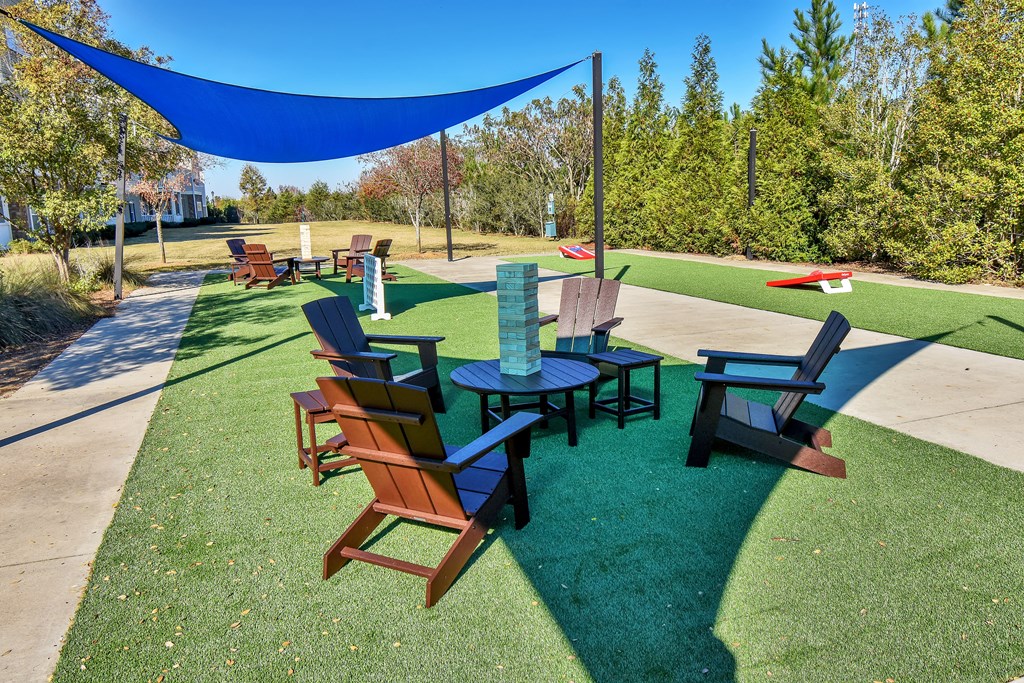 Riverstone outdoor game area with seating