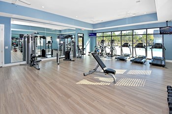 Fitness Center with natural light, hard flooring, weight and cardio equipment near the pool - Photo Gallery 19