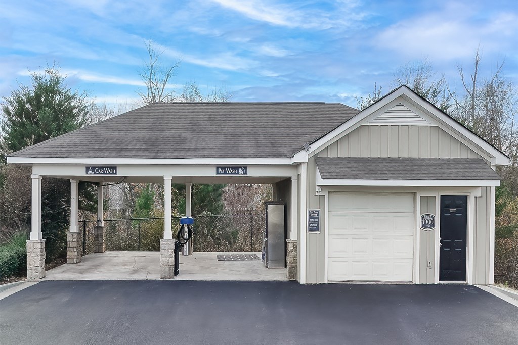 carwash and the front of a garage with a driveway and a white door