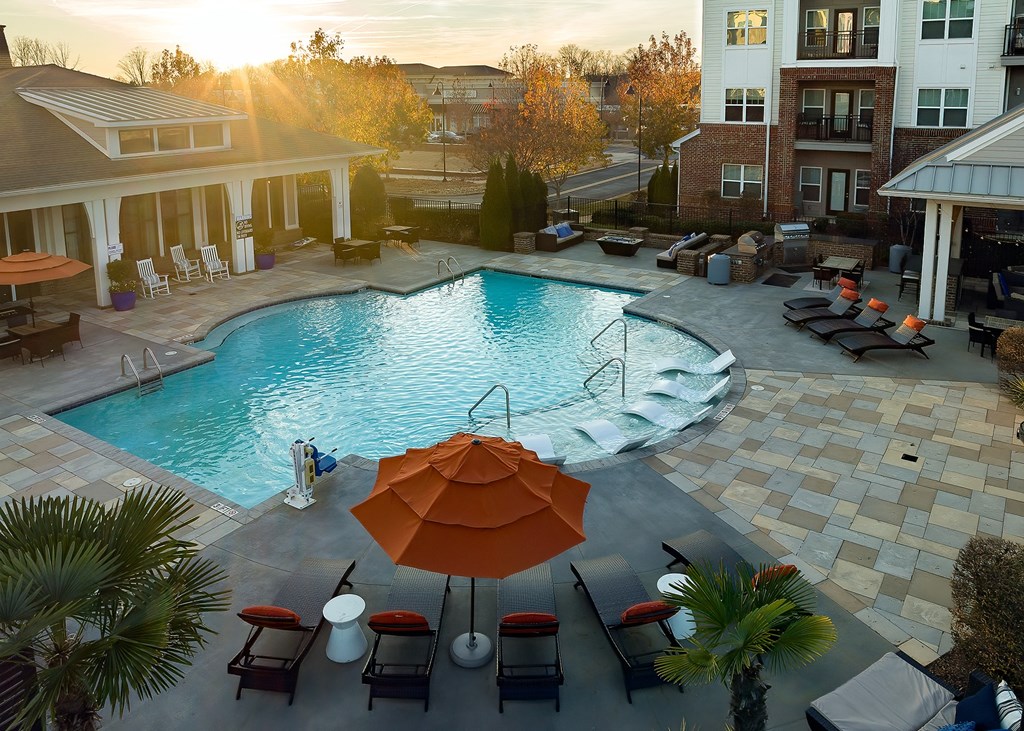 an aerial view of a swimming pool with an umbrella