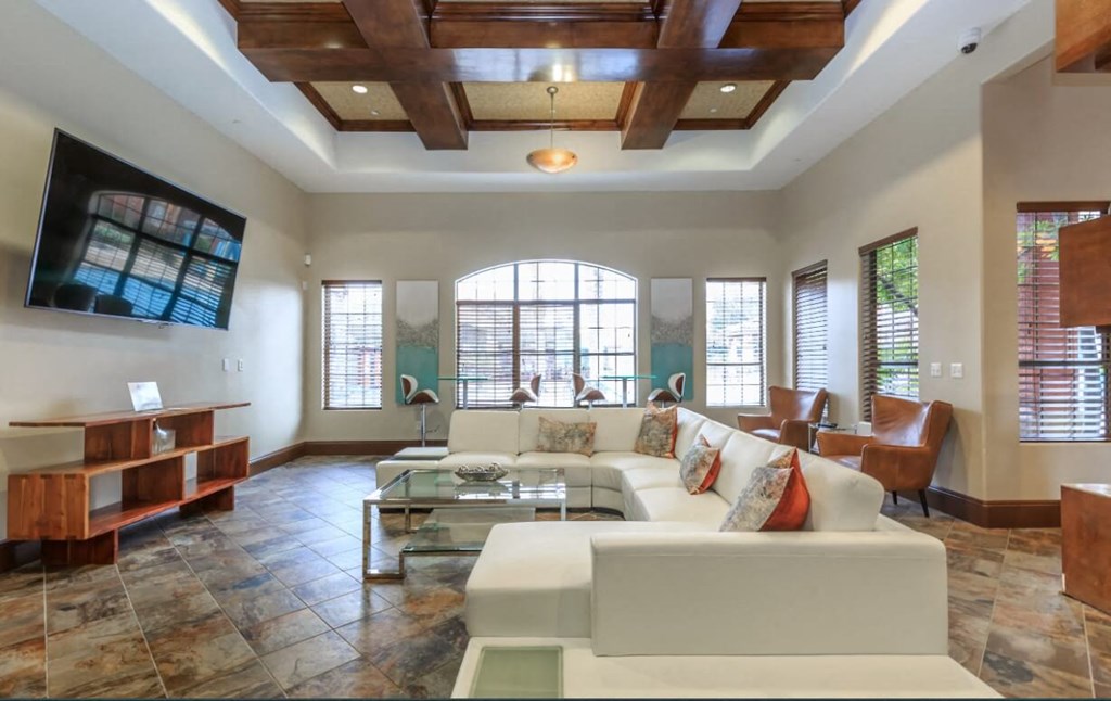 a large clubhouse with a white couch and a television