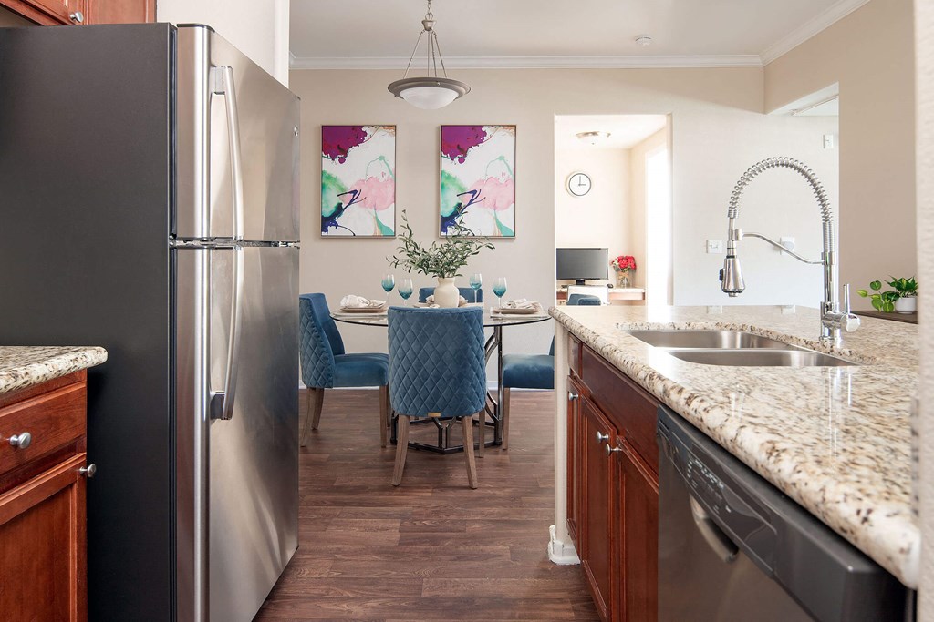 a kitchen and dining room with stainless steel appliances and granite counter tops