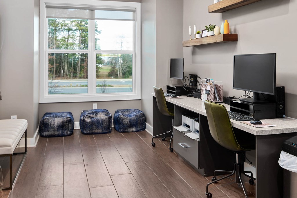 business center with desks and chairs and a window