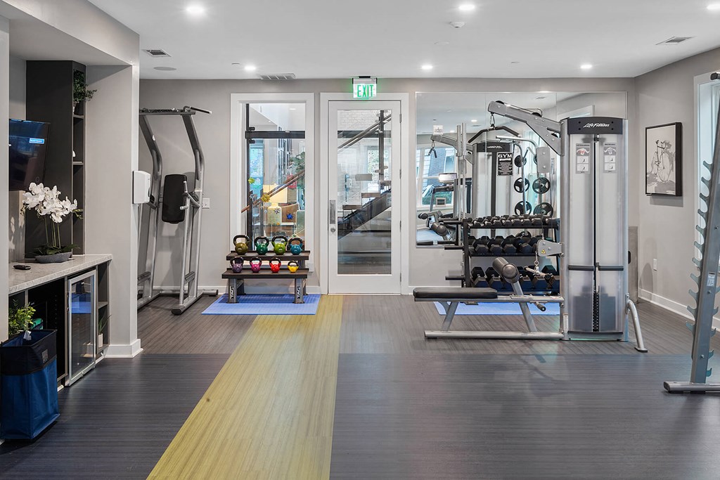 a gym with weights and cardio equipment in a home