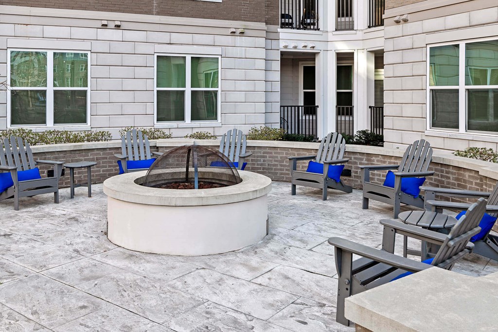 an outdoor patio with chairs and a fire pit