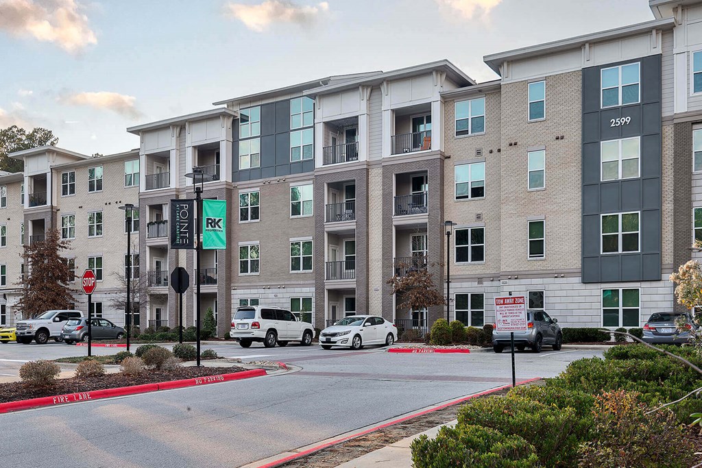 an apartment building with cars parked in front of it