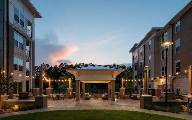 a courtyard with a pavilion in the middle of an apartment building