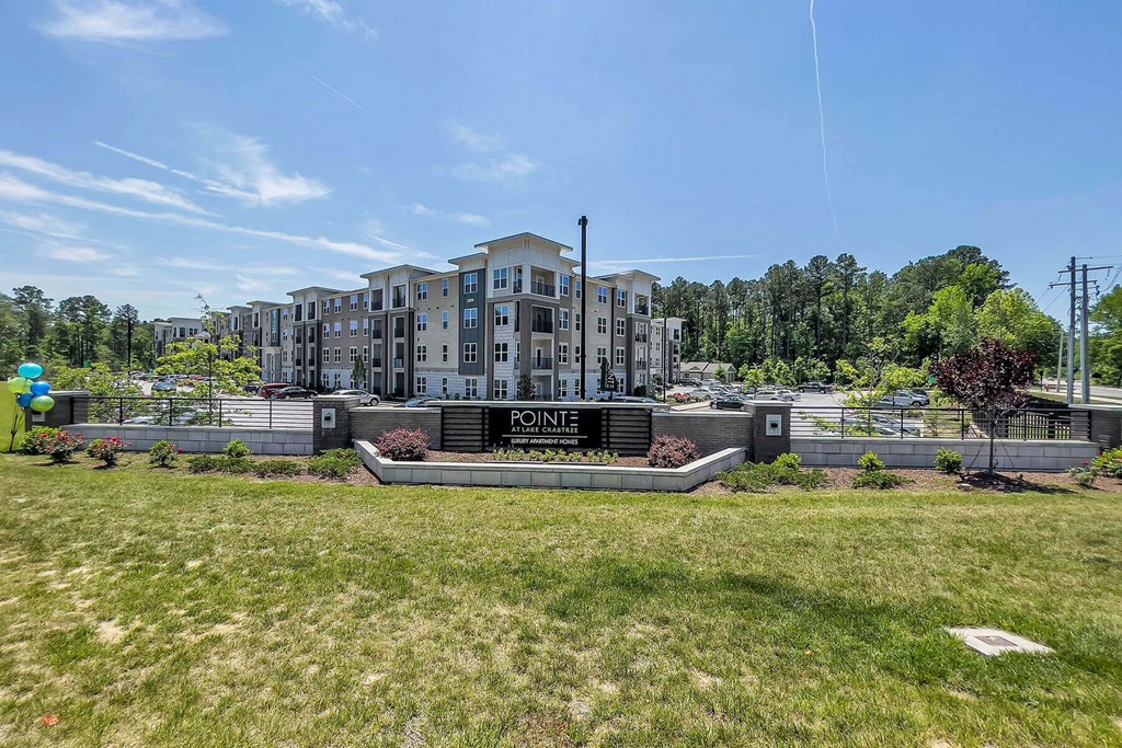 a large building with a lawn in front of it