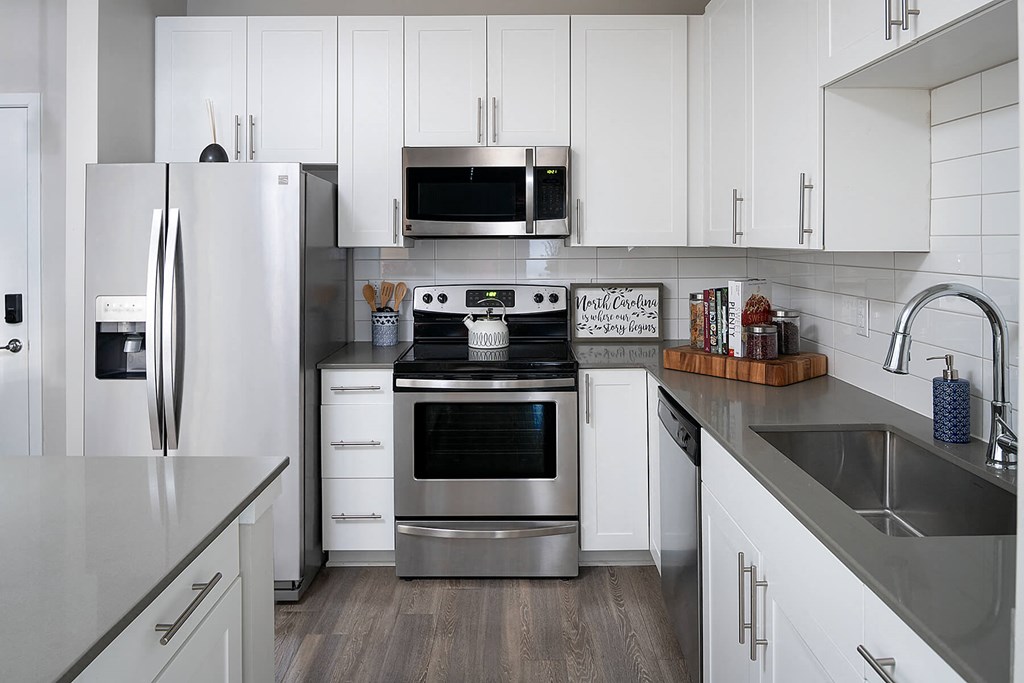 a kitchen with stainless steel appliances and white cabinets