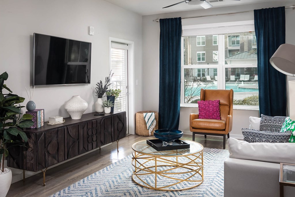 a living room with a large window and a television