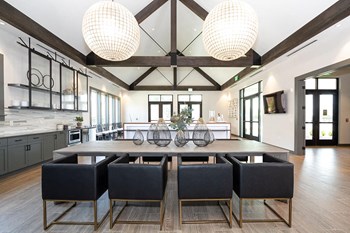 The resident clubhouse has large tables and chairs at Pointe at Research Park in Charlotte, NC - Photo Gallery 2