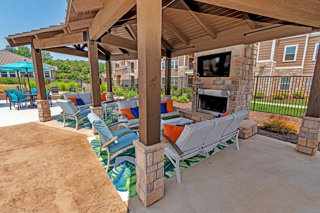 a patio with couches and a fireplace