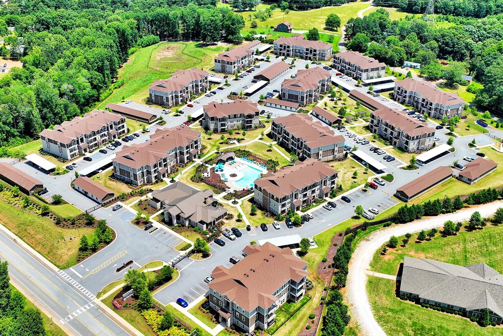 arial view of a large housing complex with a swimming pool in the middle of the road