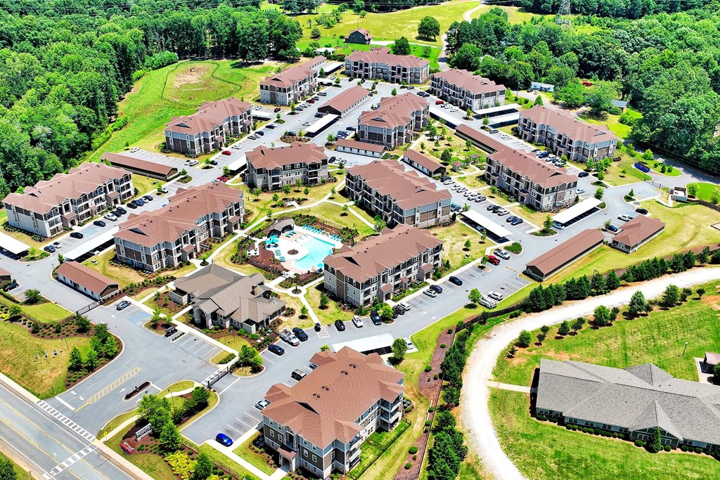 arial view of a subdivision with houses and a swimming pool