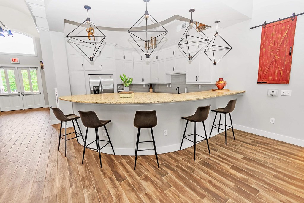 a kitchen with a large island with bar stools