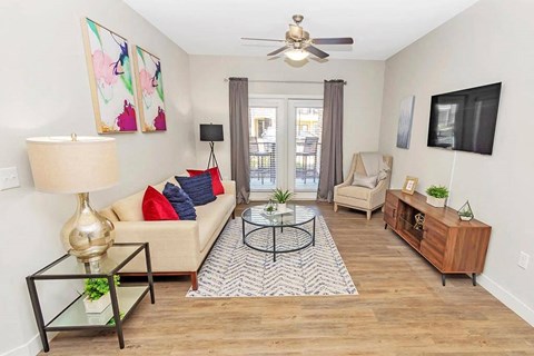 a living room with a couch and a ceiling fan