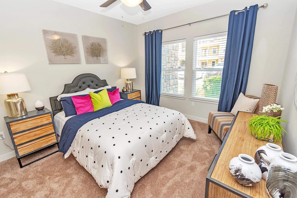 a bedroom with a bed and two windows