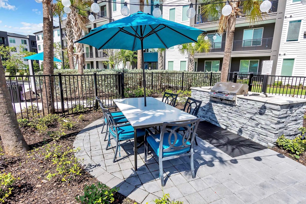 a patio with a table and chairs and an umbrella