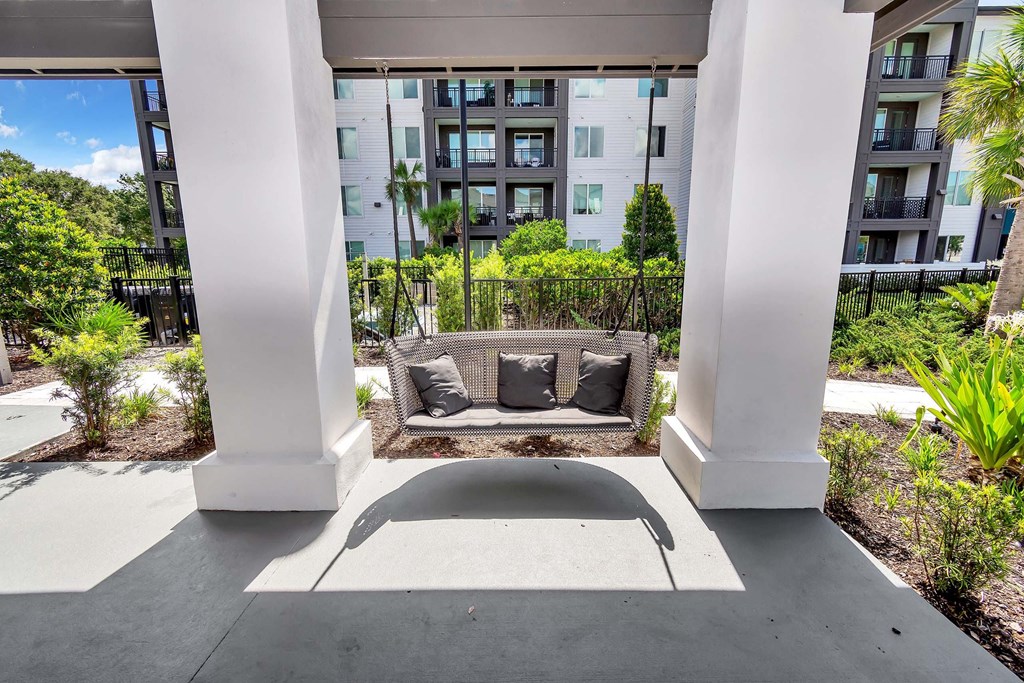 a seating area on the patio of an apartment building