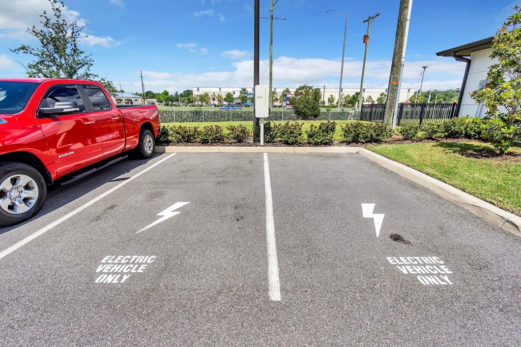 a red truck parked in a parking lot