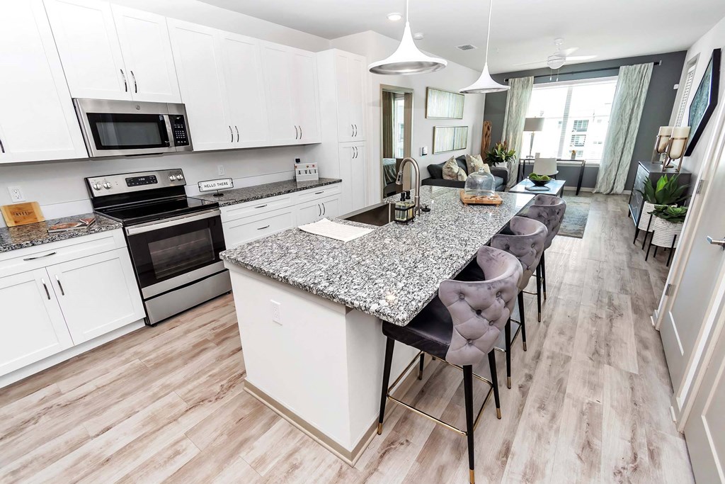 a kitchen with a center island next to a stove top oven