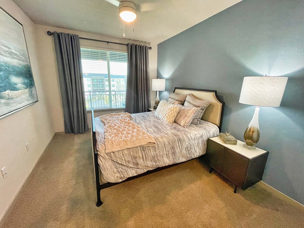 a bedroom with a bed and a window