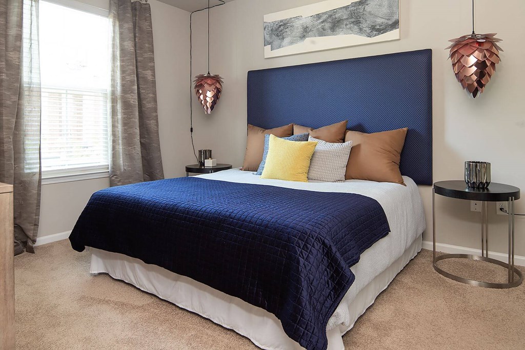 a bedroom with a large bed and a blue headboard