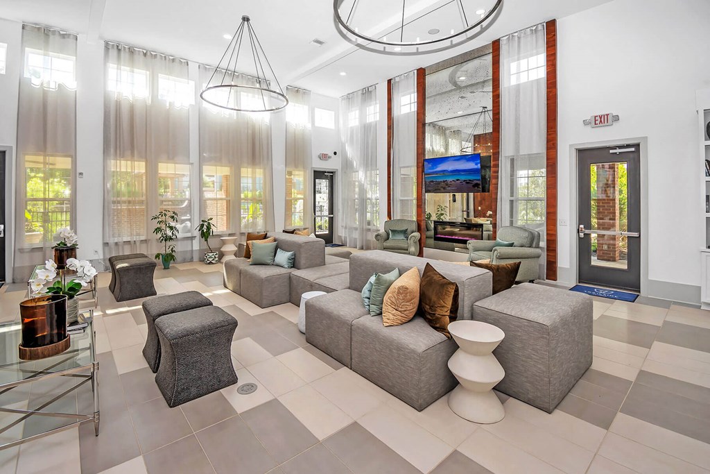 a lobby with couches and chairs and a glass door