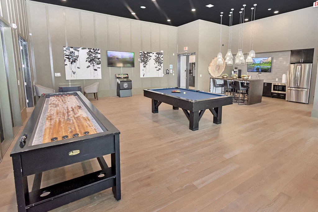 a game room with three billiards tables