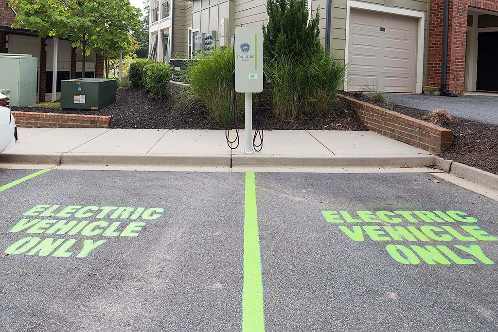 the electric vehicle only parking lot is painted green on the street
