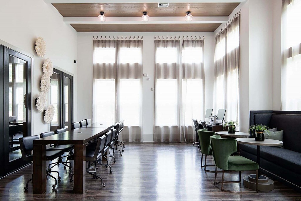 a large room with a table and chairs and windows