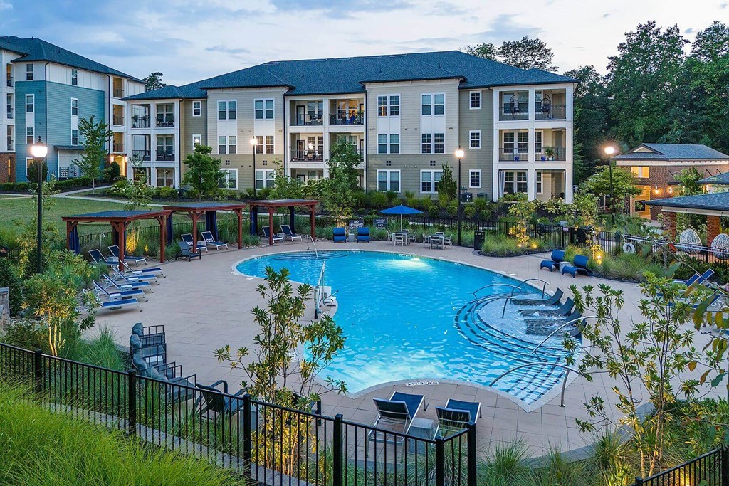 a large swimming pool in front of an apartment building