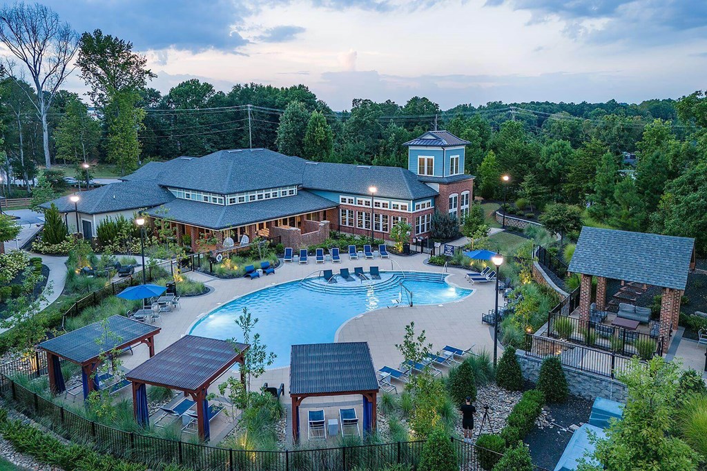 an aerial view of a resort with a large swimming pool