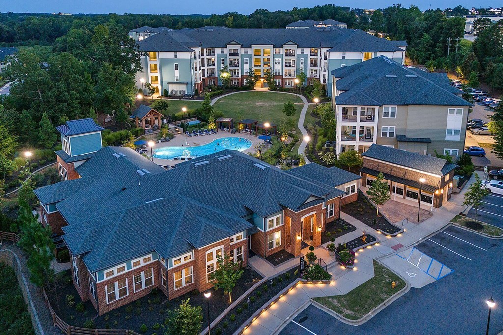 an aerial view of the resort at night with a swimming pool